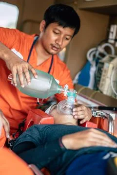 Paramedics Emergency EMS team using Reusable Manual Resuscitator or Ambu Ba.. Stock Photos