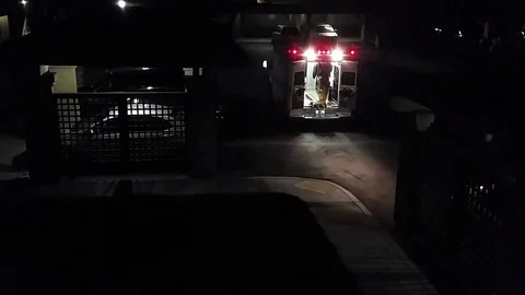Paramedics Enter and Exit an Ambulance at Night Stock Footage 77516893