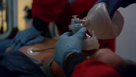 Paramedics hands providing first aid help of man with cardiac respiratory mask Stock-Footage 166866202