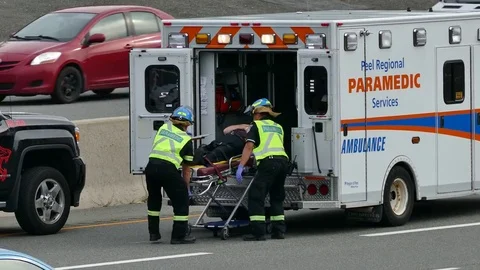 Paramedics Loading Patient Into Ambulance Video stock 69984021