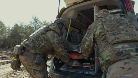 Paramedics Loading Wounded Soldier Into Medevac 스톡 동영상 347193311