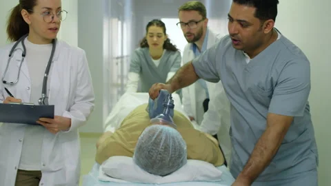 Paramedics Moving Patient on Gurney through Hospital Stock Footage 149313053