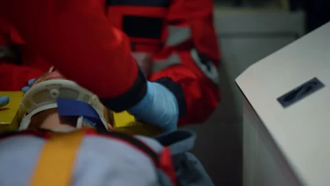 Paramedics performing first aid help of patient in emergency car Video stock 166912237