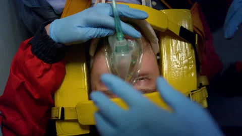 Paramedics proving first aid help to man. Doctors putting oxygen mask on patient Stock Footage 166878518