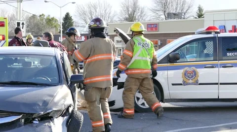 Paramedics pulling patient out of car with wrecked police cruiser Video stock 45869611