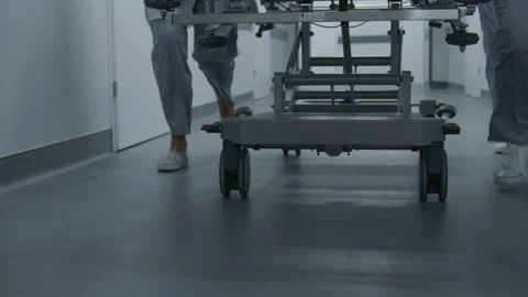 Paramedics push stretcher to operation room Stockbeeldmateriaal 250292785
