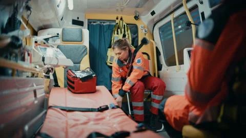 Paramedics Riding in Ambulance Using Tablet Stock Footage 141568659
