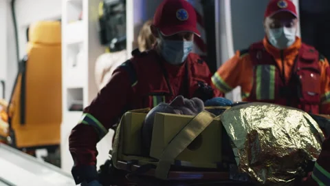 Paramedics speaking and loading unconscious man into van Video stock 166143062