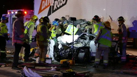 Paramedics Stabilizing Patient During Car Crash Extrication Video stock 70798007