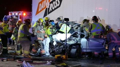 Paramedics Stabilizing Patient During Car Crash Extrication - 24fps 1080p Video stock 91563404