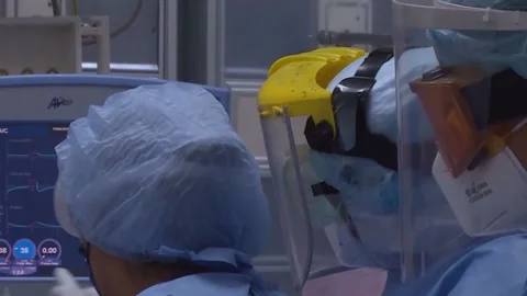 Paramedics transfer the patient with a coronavirus to the couch. Covid 19 Stock Footage
