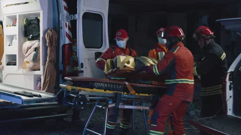 Paramedics transporting patient at night Stock-Footage 166141441