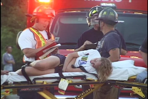 Paramedics Treat Woman on Gurney 2 Stock Footage