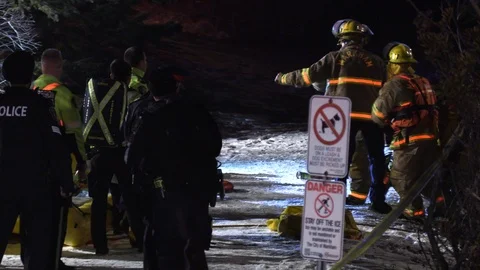 Paramedics try to rush and revive drowning victim on stretcher to ambulance Stock Footage 100657347