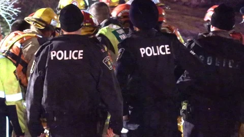 Paramedics try to rush and revive drowning victim on stretcher to ambulance Stock Footage 100657387