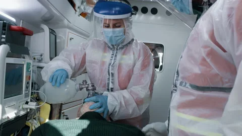 Paramedics using oxygen pump on patient Video stock 167965423
