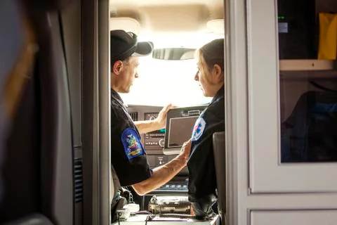 Paramedics using tablet computer while sitting in ambulance Stock Photos