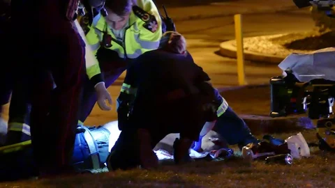Paramedics Working Hard to Stabilize Shooting Patient At Scene Stock Footage 76756207