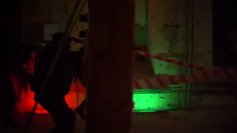 Paramilitaries armed men attack and fire automatic weapons on the run In Dark Stock Footage 186933169