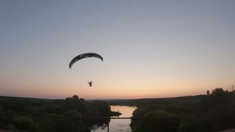 Paramotor flies near over the river Stock Footage 178582813