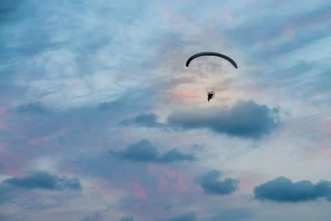Paramotor flight in horizontal sunset sky Stock Photos