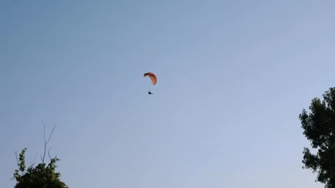 Paramotor flying in sky Stock Footage 347653976