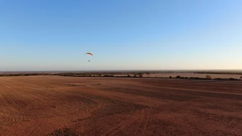 Paramotor flying in summer day at Granite Field South Australia. Video stock 115788503