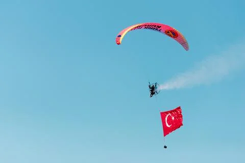 Paramotor jumper on the sky with a huge Turkish flag on the liberty day of Iz Stock Photos