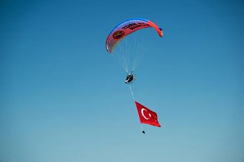Paramotor jumper on the sky with a huge Turkish flag on the liberty day of Iz Stock Photos
