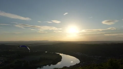 Paramotor performs aerial stunts at sunset in Moselle Stockbeeldmateriaal 332109132