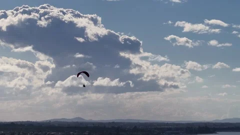 Paramotor Pilot Flying Over Surfers Paradise with Large Clouds Stockbeeldmateriaal 342086789