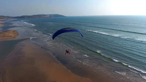 Paramotor Soaring Above the Ocean Coastline (Aerial View) Stock Footage 323943256