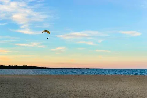Paramotor in the sunset shifting over the beach. Stock Photos