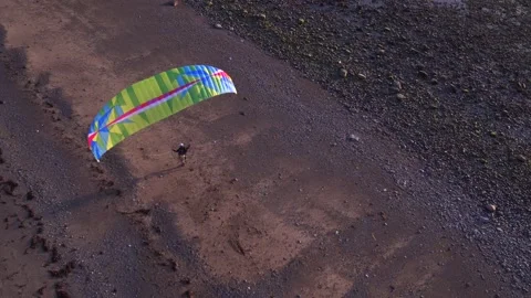 Paramotor taking off and flying along the coast Stock Footage 142064074