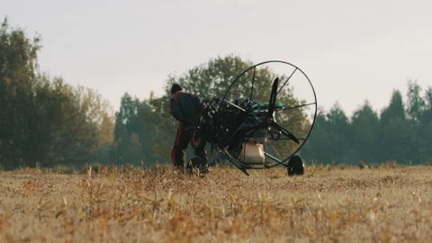 Paramotorgliding. Man successfully landed on the field Stock Footage 137811801