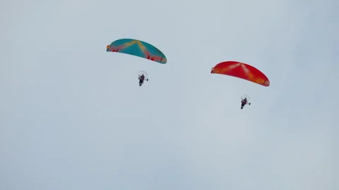 Paramotors flying clear sky. Two powered paragliders soaring high above earth. Video stock 318201506