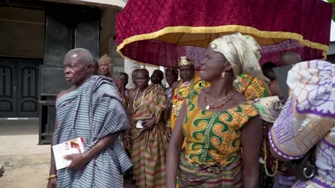 A paramount chief and king march with his entourage under the royal Stock Footage 130564923