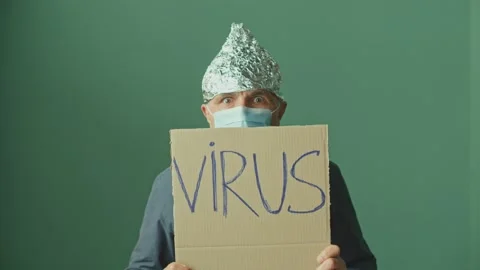 A Paranoid Man in a Foil Cap and a Medical Mask. Mental Problems. Stock Footage 166706045