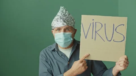 A Paranoid Man in a Foil Cap and a Medical Mask. Mental Problems. Video stock 166706071