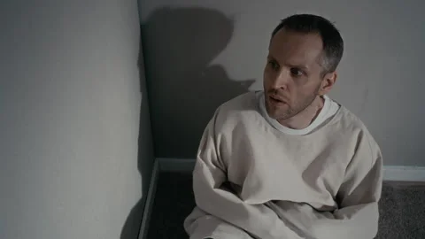 Paranoid Man Wearing Straitjacket Sitting in Psychiatric Ward Vídeos de archivo 336661796