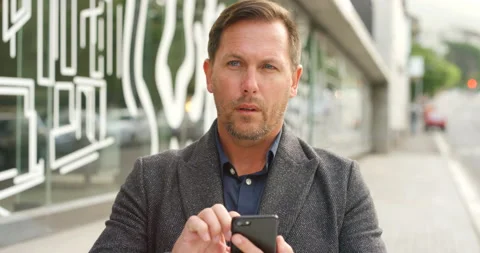 Paranoid mature man using a phone and worried about privacy and surveillance in Video stock 201315574