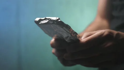 Paranoid Person Using a Smartphone Covered in Tin Foil Aluminium Stock Footage 136130522