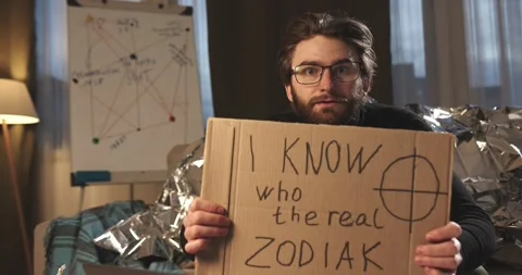 A paranoid, a supporter of pseudoscience holds a sign with a conspiracy slogan. Stock Footage 272253027
