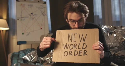 A paranoid, a supporter of pseudoscience holds a sign with a conspiracy slogan. Stock Footage 272253351