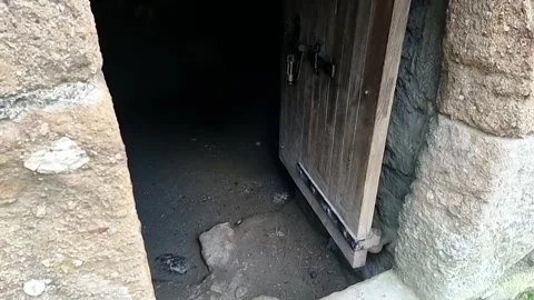 Paranormal ghostly orb light floating across old medieval wooden doorway Video stock 249501213