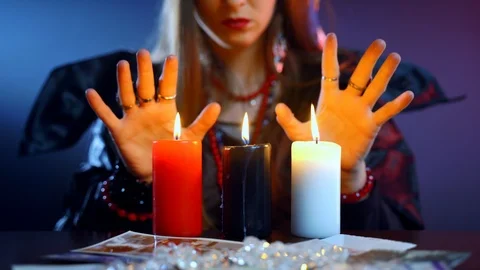 Paranormal witch ritual performance in dark room with three burning candles and Vídeo Stock 121967618
