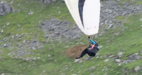 A Paraponter flying below Red Screes near Ambleside, Lake District, UK. Stock Footage 255676430