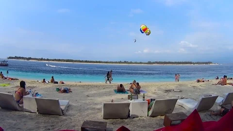 Parasail in front of shoreline, tropical island Stock Footage