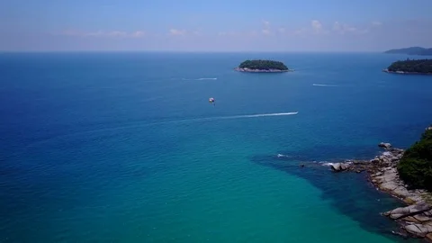 Parasail wing soar over beautiful tropical sea, turn about rocky cape, aerial Stockbeeldmateriaal 80239108