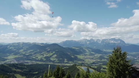 Parasailer Glides Through Summer Mountains in Austrian Alps Stock Footage 148187622